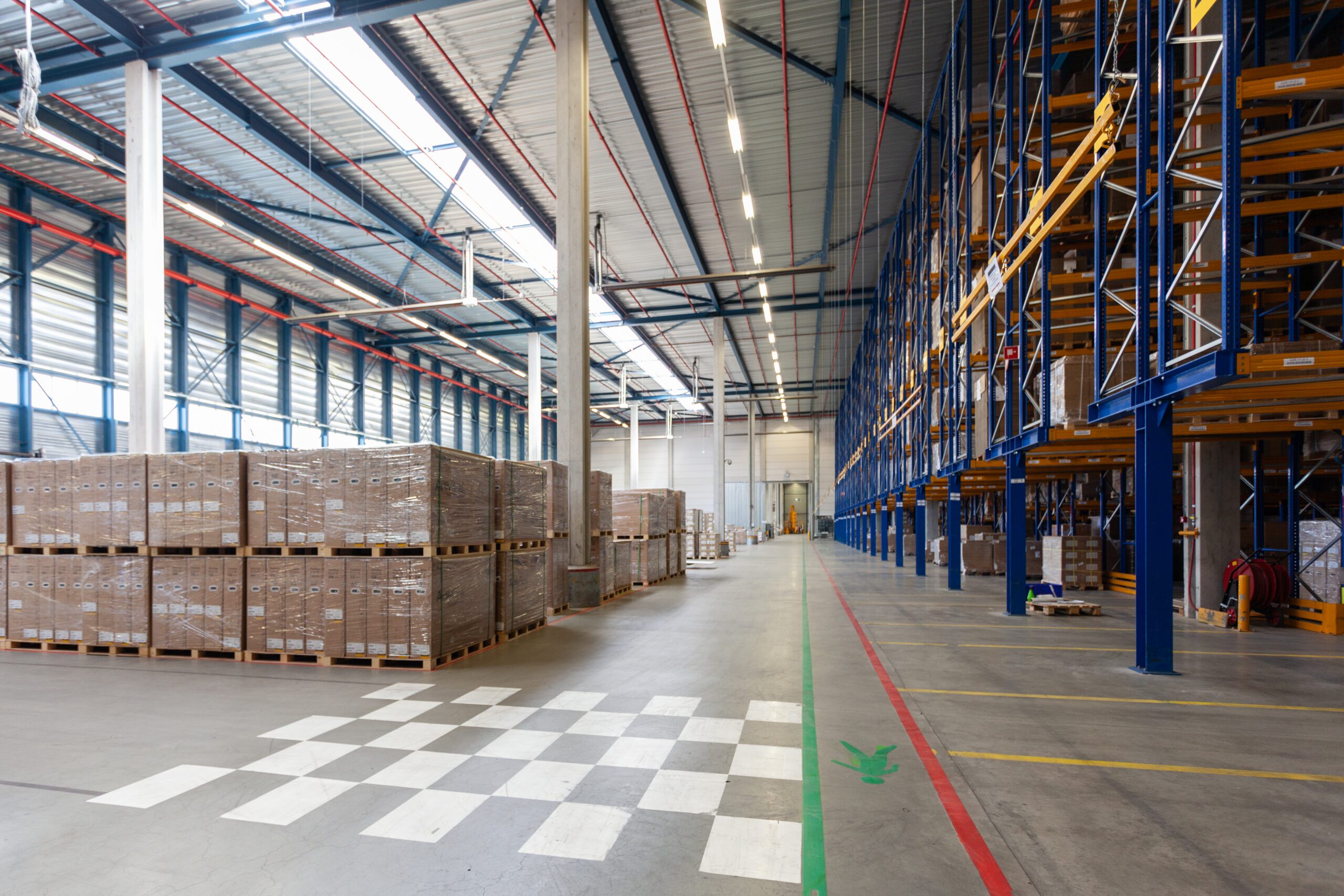 Spacious warehouse aisle with pallets and racks